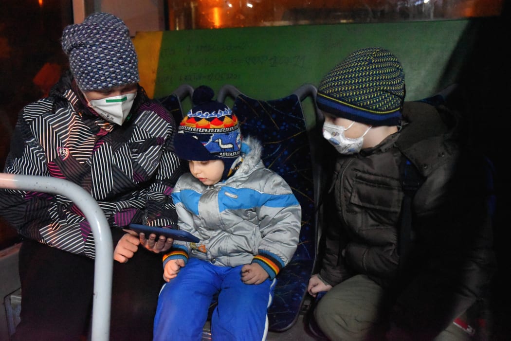 Children sit in a bus waiting for evacuation from Donetsk, Ukraine to Rostov region, Russia on 18 February, 2022.