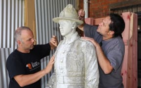 Statue of Warrant Officer Class II. Sergeant Major, Herewini Whakarua.
Marco Buerger and Aaron Te Rangiao from Goldfield Stone, working on the statue.