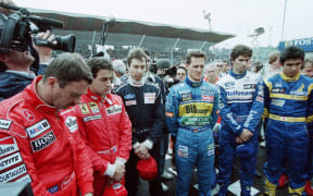 Drivers observe a minute of silence in memory of Ayrton Senna and Roland Ratzenberger, moments before the start of the F1 San Marino Grand Prix in Imola on April 30, 1995.