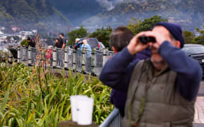 Onlookers watch the grounded ferry from Picton