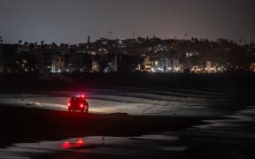 A LA County Lifeguard truck patrols Venice beach pier amid a tsunami warning in Los Angeles, California on 30 July, 2025.