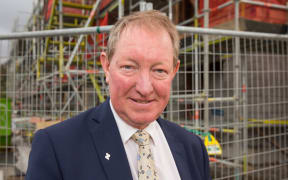 Nick Smith outside one of the Special Housing Areas in Auckland