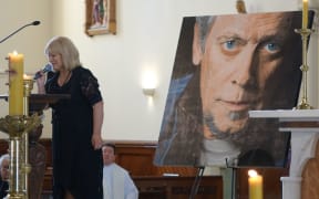 Suzanne Lynch sings wind beneath my wings at ray Columbus funeral.