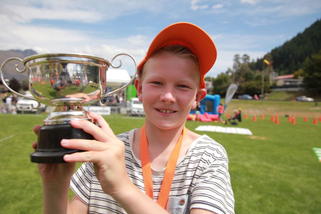 10-year-old Adam Stevens from Invercargill with the Bill Tapley Trophy for cow pat tossing