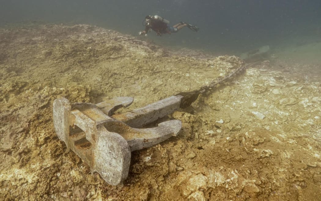 The Manawanui's anchor is seen on the reef, with its chain causing damage as it sways with the currents.