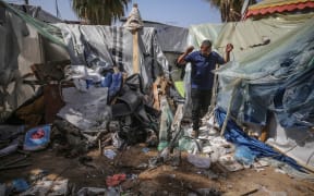 Palestinians are checking the damage at a makeshift camp for displaced people in front of the Al-Aqsa Martyrs Hospital in Deir al-Balah in the central Gaza Strip, after it was hit by an Israeli bombardment on March 31, 2024, amid the ongoing battles between Israel and the Hamas militant group. (Photo by Majdi Fathi/NurPhoto) (Photo by MAJDI FATHI / NurPhoto / NurPhoto via AFP)