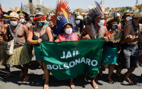 Indigenous people protest in front of the Planalto Palace in Brasilia on August 26, 2021.