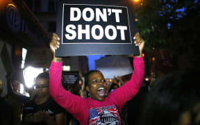 A woman holds a banner during a protest in support of the Black lives matter movement in New York.