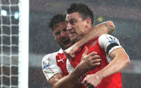 Laurent Koscielny celebrates after scoring a goal for Arsenal.