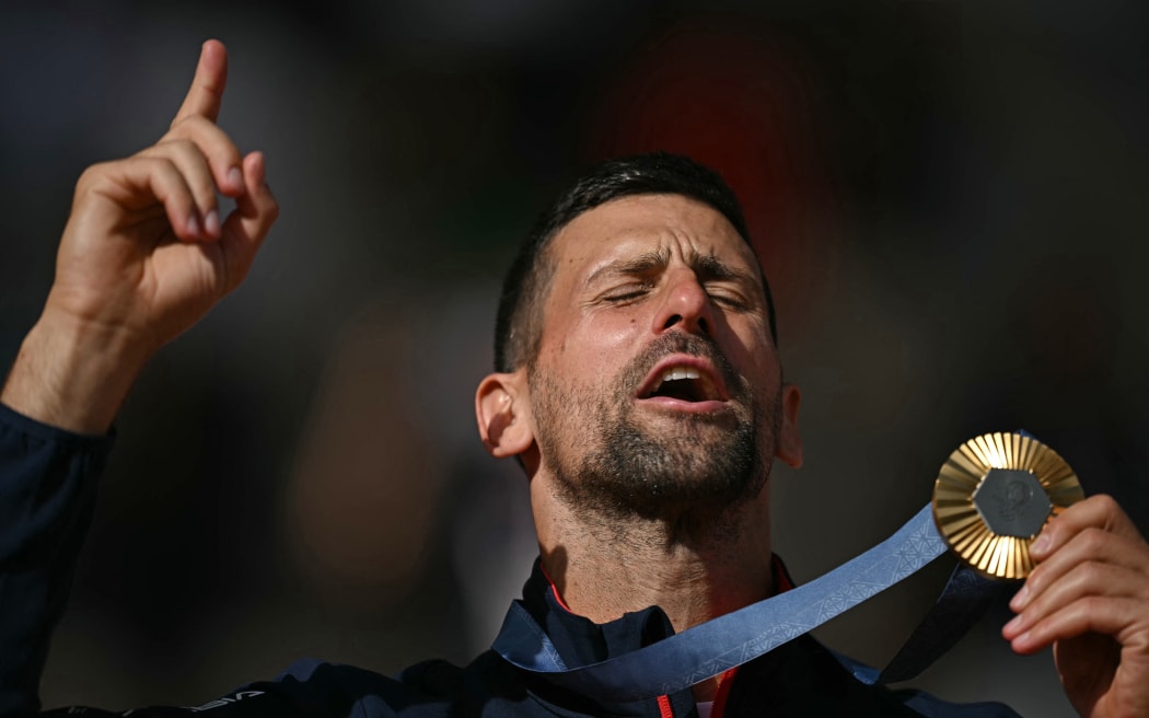 Novak Djokovic poses with his Paris Olympics men's singles gold medal.