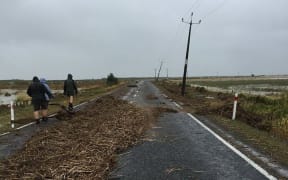 Debris cover the road in the small settlement of Kaiaua on the western side of the Firth of Thames.