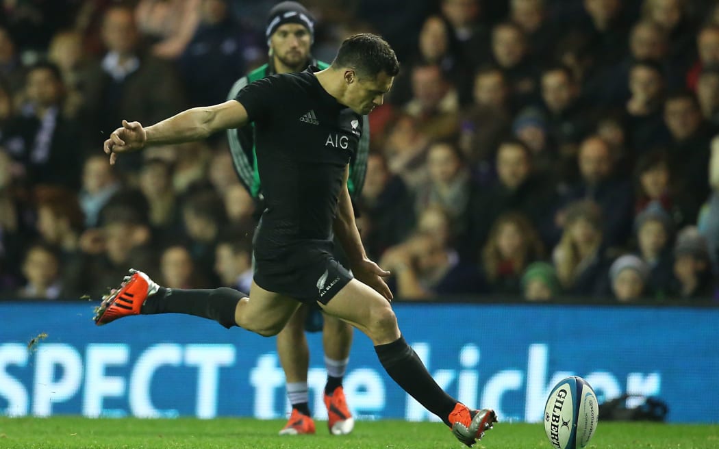 Dan Carter kicks a penalty as Aaron Cruden watches from the sidelines