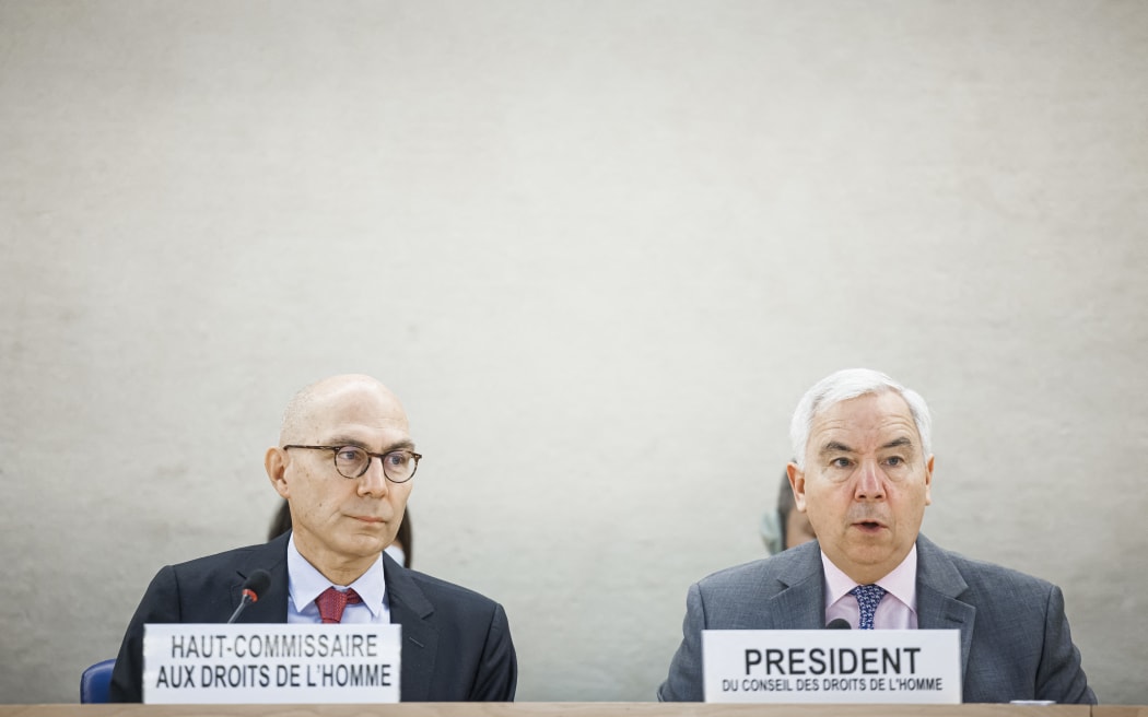 High Commissioner for Human Rights Volker Turk listens as UN Human Rights Council President Federico Villegas adresses the assembly during a special session of the UN Human Rights Council on the situation in Iran, in Geneva.