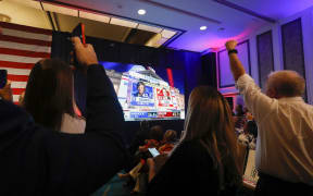 People cheer as they watch live election results projecting Rubio as the winner as they attend an election night watch party for US Senator Marco Rubio (R-FL) at Hilton Miami Airport Blue Lagoon in Miami, Florida, on 8 November, 2022.