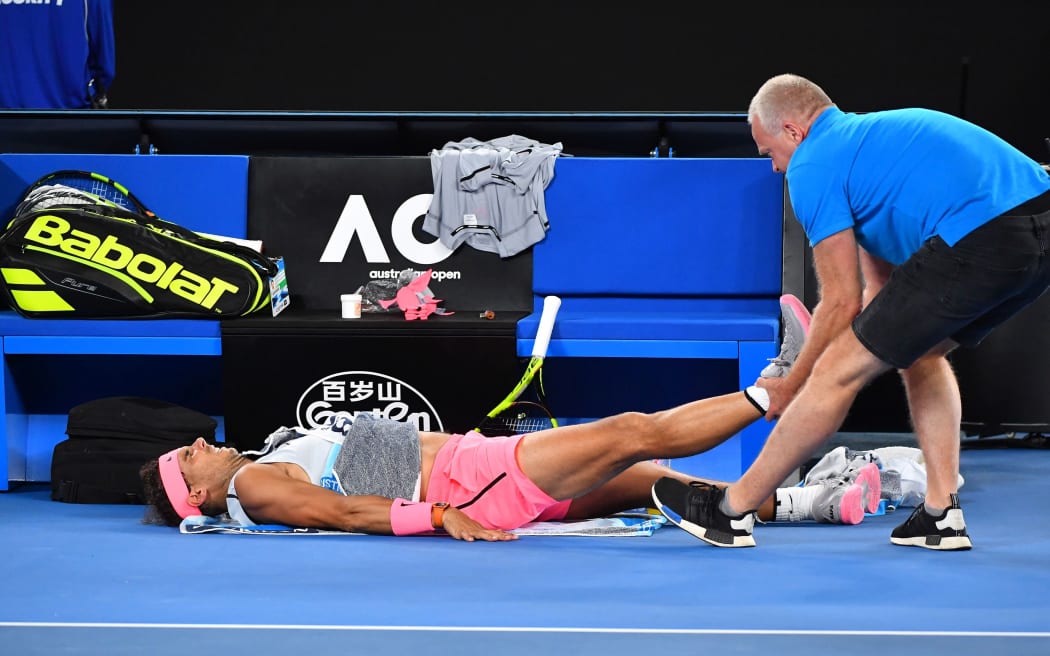 Rafael Nadal (Esp) gets treatment for his leg injury.