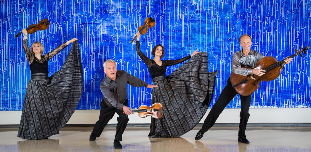 New Zealand String Quartet dance against a John Reynolds art work