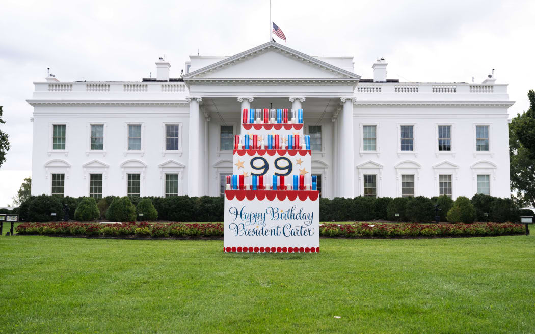 A sign wishing a happy birthday to former US President Jimmy Carter sits on the North Lawn of the White House in Washington, DC, September 30, 2023, ahead of his 99th birthday on October 1. (Photo by SAUL LOEB / AFP)