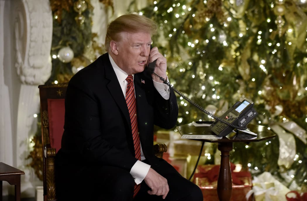 US President Donald Trump participates in NORAD Santa Tracker phone calls in the White House .