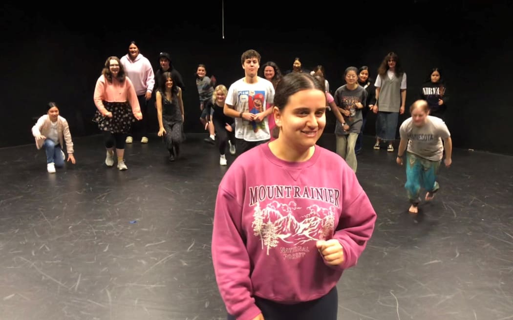 A group of university students, casually dressed, playing drama games.