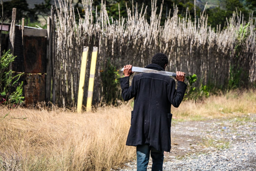 a man with a machete on PNG Highlands Highway