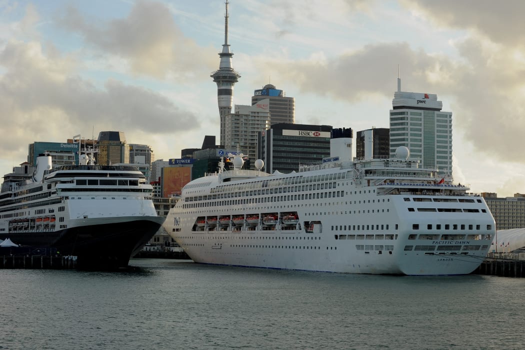 Cruise ships (C) lie tied up at Auckland's Viaduct Harbour during the 2011 Rugby World Cup on October 14, 2011. Auckland in New Zealand's North Island has the largest urban area in the country with just over one million people living there.  AFP PHOTO / Greg WOOD (Photo by GREG WOOD / AFP)