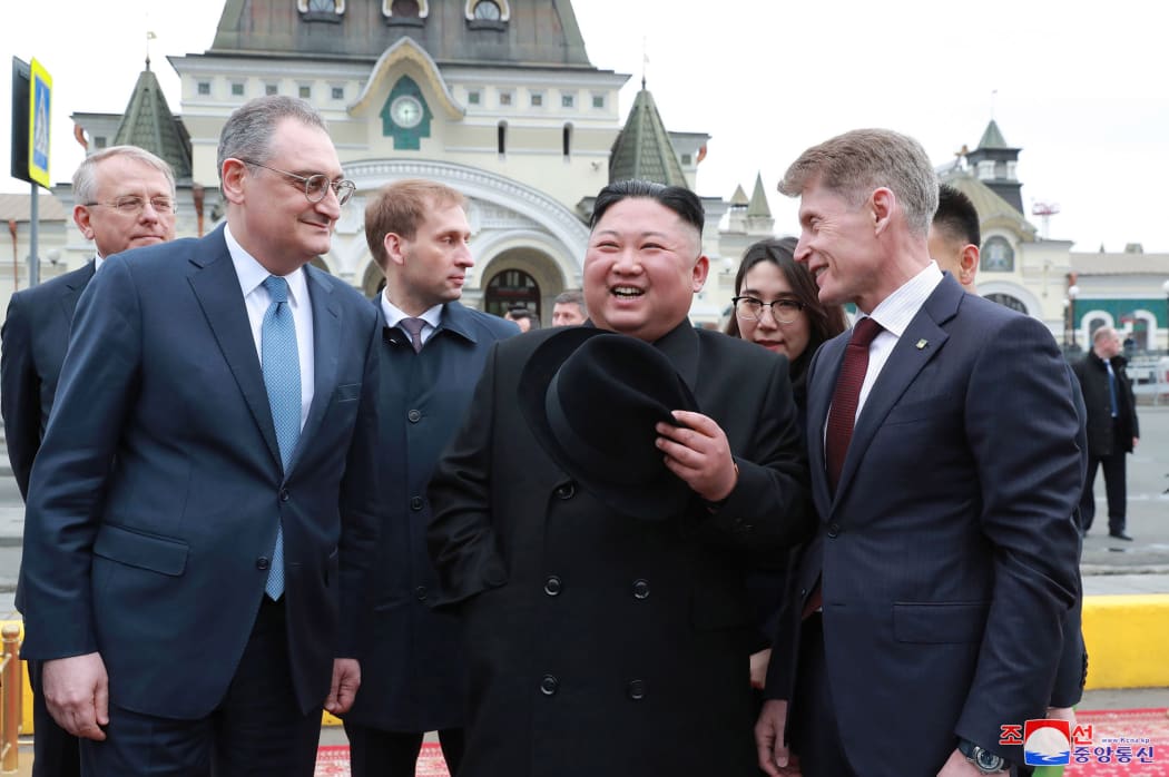 North Korean leader Kim Jong Un, centre, is welcomed by Russian officials on his arrival in Vladivostok, Russia.