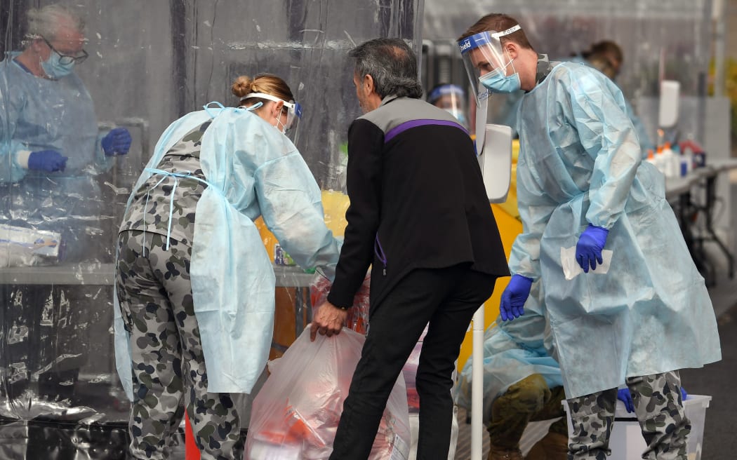 Members of the Australian Defence Force package swab samples ready for testing at a drive-through COVID-19 coronavirus testing station in the Melbourne suburb of Fawkner on July 2, 2020.