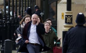 People are evacuated from the Houses of Parliament in central London after an attacker mowed down pedestrians and stabbed a police officer to death.