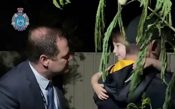 Cleo Smith being rescued by police in Carnarvon, Western Australia, shown in a screengrab of a video released by police.