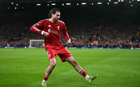 Liverpool's Hungarian midfielder Dominik Szoboszlai celebrates.