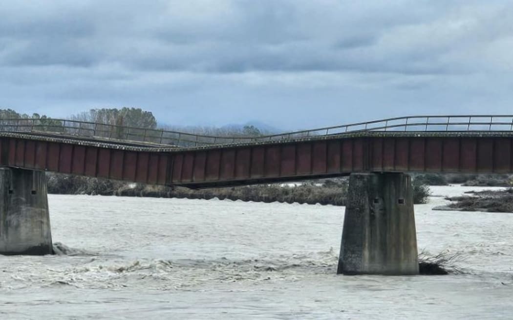 A 610m-long rail bridge over the Rangitata River, South Canterbury, sags after flood water washed away one of 34 piers. PHOTO: CONNOR HALEY
