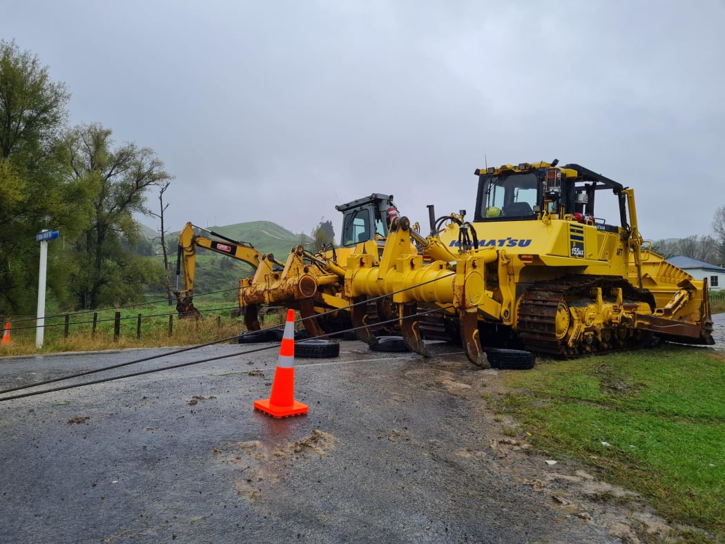 Bulldozers reinforce a bridge on Ruakituri Road near the Te Reinga falls on Wednesday 13 April 2022.