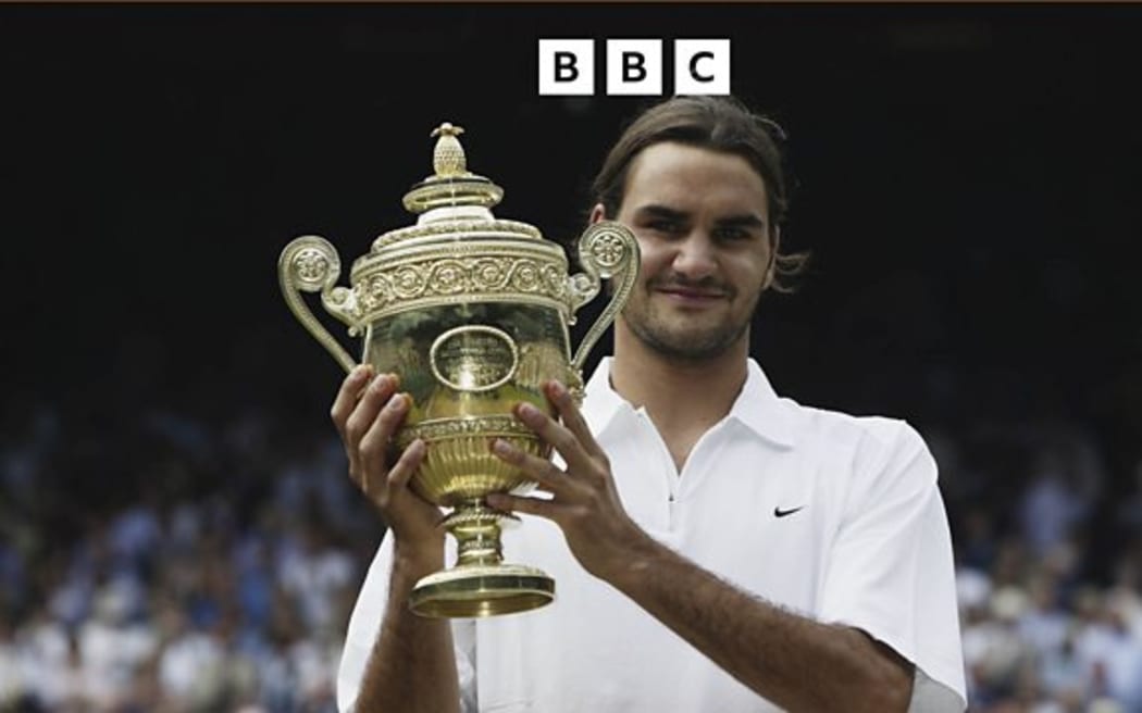 Roger Federer holds the trophy after his victory over Mark Philippoussis in the Men's Singles Final at the Wimbledon Lawn Tennis Championships on July 6, 2003 at the All England Lawn Tennis and Croquet Club, in Wimbledon.