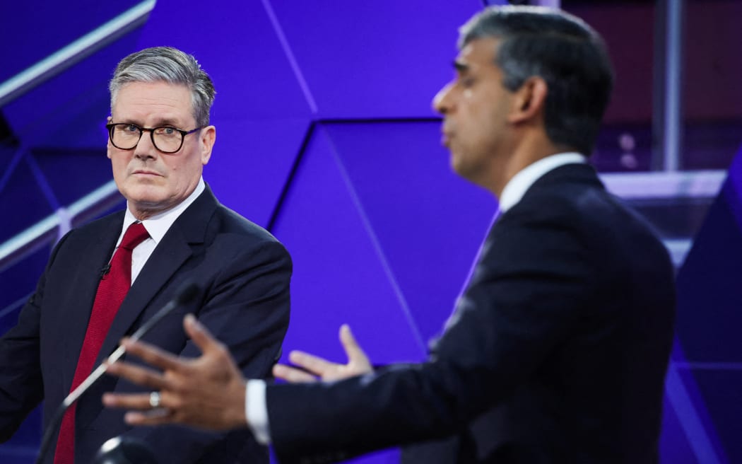 Britain's main opposition Labour Party leader Keir Starmer reacts as Britain's Prime Minister and Conservative Party leader Rishi Sunak speaks during a live TV debate, hosted by The BBC, in Nottingham, on June 26, 2024, in the build-up to the UK general election on July 4. (Photo by Phil Noble / POOL / AFP)