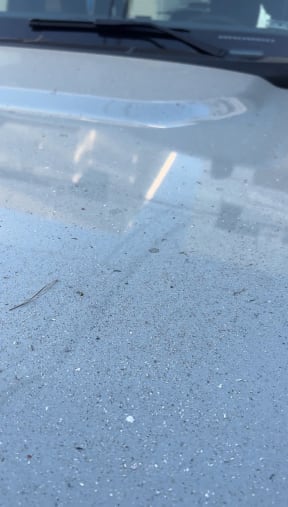 A car bonnet covered in ash from the Palisades fire.