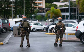 French soldiers of the 8th Marine Infantry Regiment (8e RIMa) secure the Magenta airport in Noumea, France's Pacific territory of New Caledonia, on May 17, 2024. France deployed troops to New Caledonia's ports and international airport, banned TikTok and imposed a state of emergency on May 16 after three nights of clashes that have left four dead and hundreds wounded. Pro-independence, largely indigenous protests against a French plan to impose new voting rules on its Pacific archipelago have spiralled into the deadliest violence since the 1980s, with a police officer among several killed by gunfire. (Photo by Delphine Mayeur / AFP)