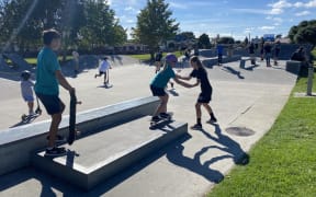 Children learning to skateboard.