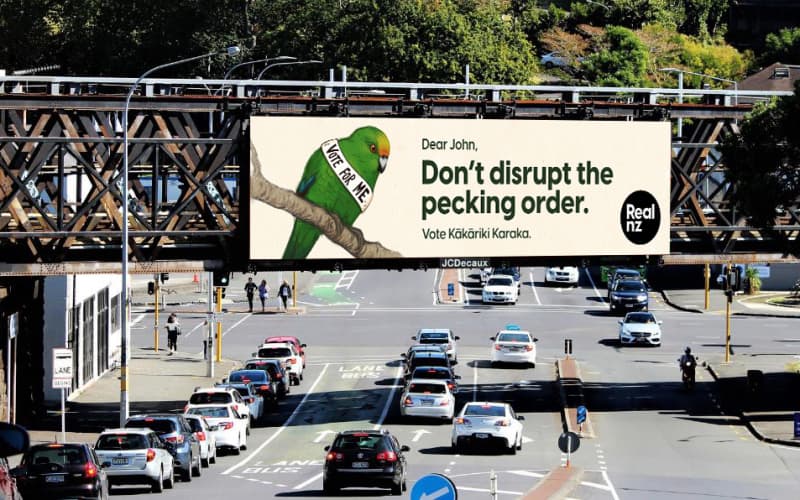 A billboard showing the RealNZ kākāriki karaka Bird of the Century campaign.