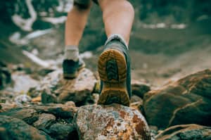 A person hiking over some rocks.