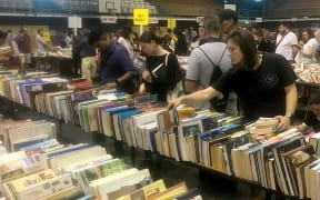 Crowds page through the bargains every year at the GABBS Book Fair in Auckland.