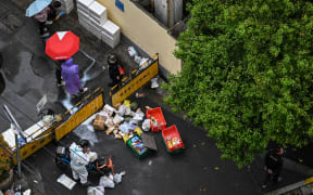 People at a street checkpoint in the Jing'an district of Shanghai during lockdown.