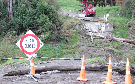A road closed sign signals the end of Rakaiatai Road. The remains of the old bridge are visible in the background.