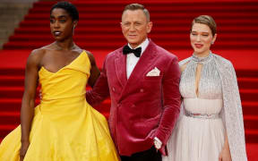 English actor Lashana Lynch (L), English actor Daniel Craig (C) and French actor Lea Seydoux pose on the red carpet after arriving to attend the World Premiere of the James Bond 007 film "No Time to Die"