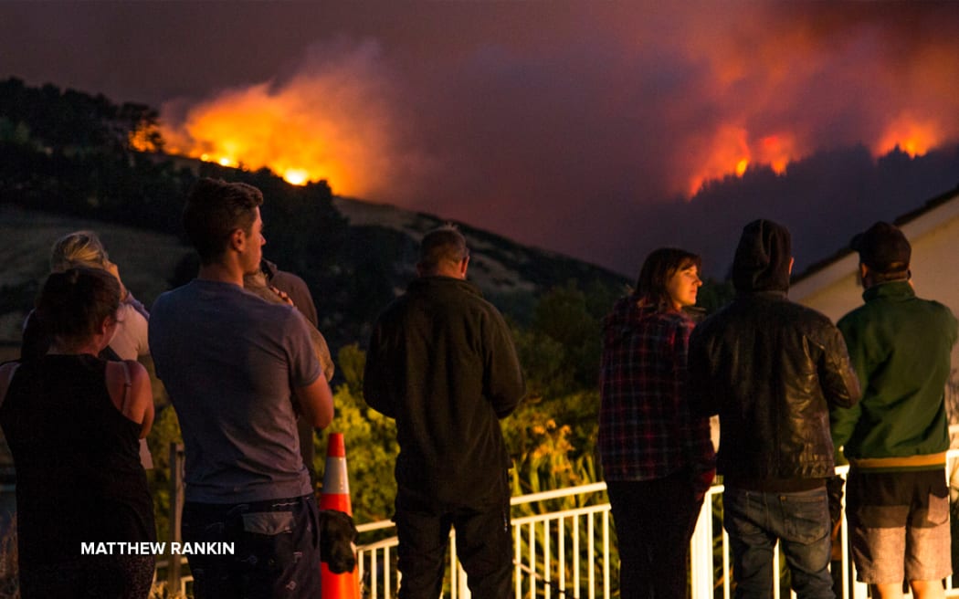 People watch on as the Port Hills fires rage