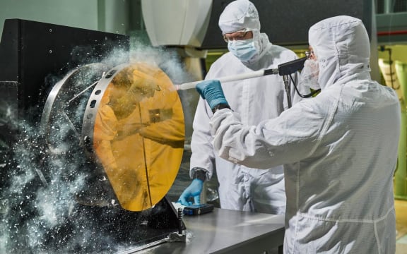 engineers are practicing "snow cleaning'" on a test telescope mirror for the James Webb Space Telescope at NASA's Goddard Space Flight Center in Greenbelt, Maryland.