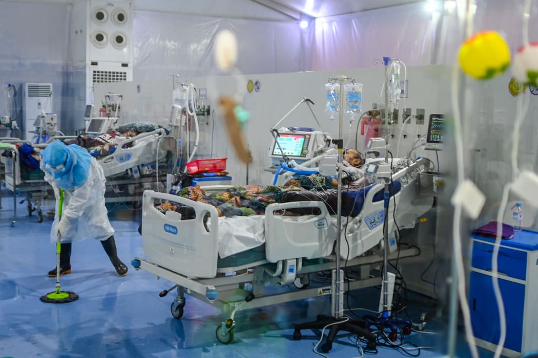 A doctor cleaning the floor of the intensive care unit at the Covid Center at the Thuwana football stadium in Yangon, Myanmar, on 1 January, 2021.