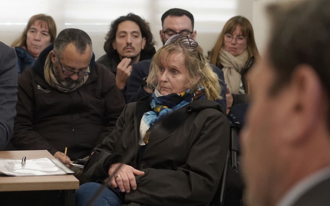 Argentine Patricia Kadgien (C), daugther of SS financial guru Friedrich Kadgien, one of several high-ranking Nazis to escape to Argentina after the war, attends a hearing after being arrested in Mar del Plata, Buenos Aires province on September 4, 2025. Argentine authorities recovered an 18th century painting stolen by Nazis from a Dutch Jewish art collector over a week after it appeared in a property ad only to suddenly vanish. The "Portrait of a Lady" by Italian baroque painter Giuseppe Ghislandi was hanging above a green sofa in the living room of Patricia Kadgien' house. (Photo by AFP)