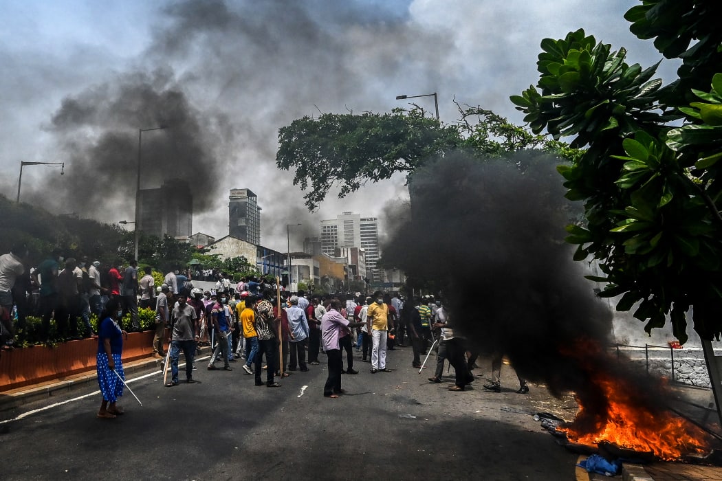 Demonstrators and government supporters clash outside the official residence of Sri Lanka's Prime Minister Mahinda Rajapaksa, in Colombo on May 9, 2022.