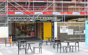 Tables set up outside a cafe near Britomart Station, lower Queen Street, Auckland.