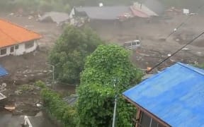 This grab taken from handout video released by a local resident and received via Jiji Press shows mud and debris at the scene of a landslide in Atami city, Japan